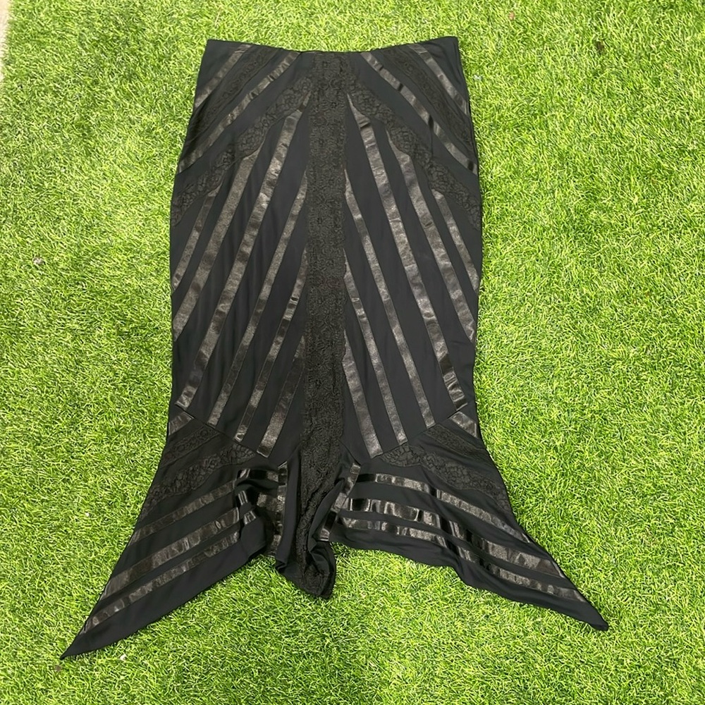 Ladies black flair skirt with satin stripes and lace detailing.